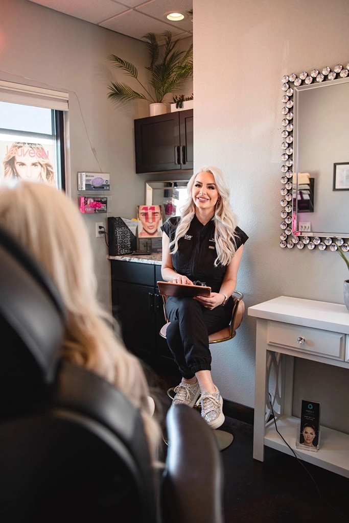 Medical spa provider discussing personalized body treatment options with a patient during a one-on-one consultation.